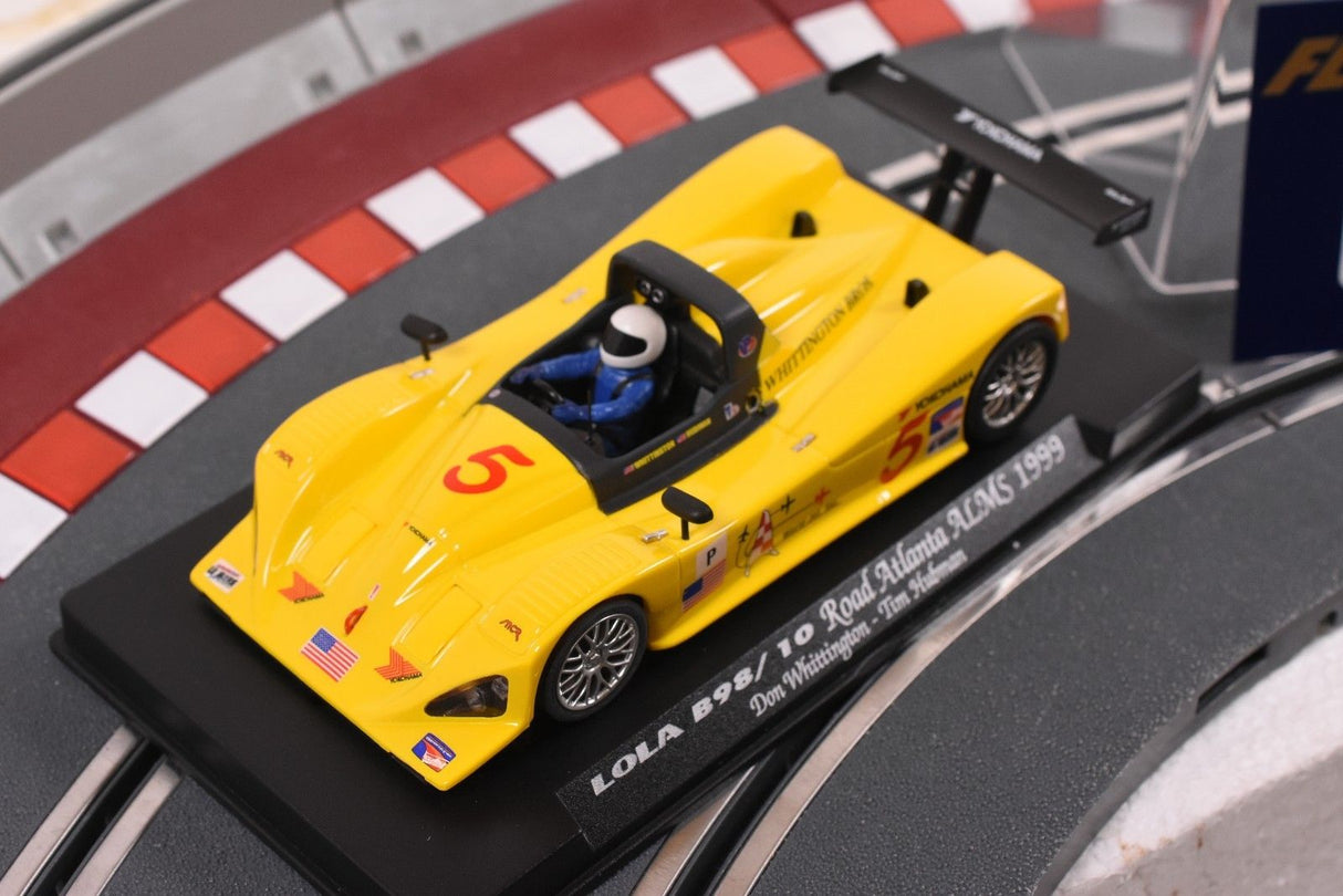 Yellow race car model on a track base, commemorating the 1999 Road Atlanta ALMS for Fly Car 88038