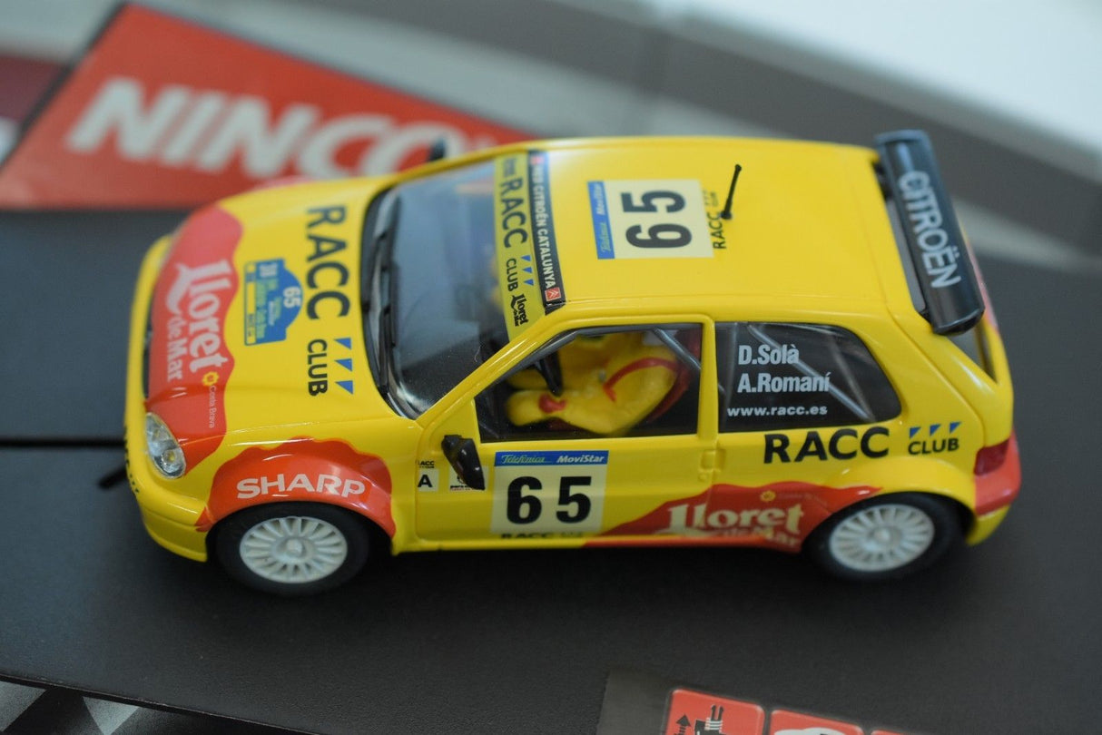 Yellow Citroen Saxo race car model with "RACC" and "Iloret" decals for Ninco 50266