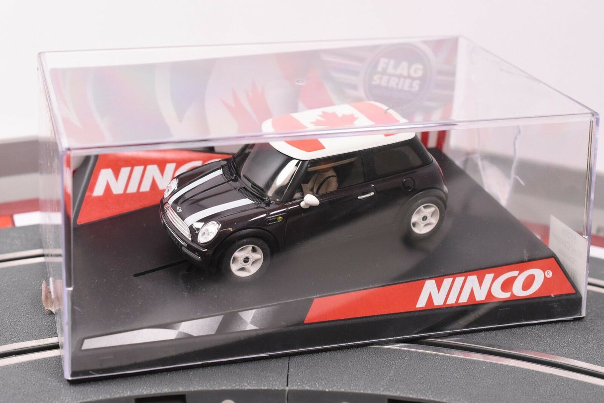 Black mini cooper slot car with Canadian flag roof, in clear display case for REH Ninco 50309