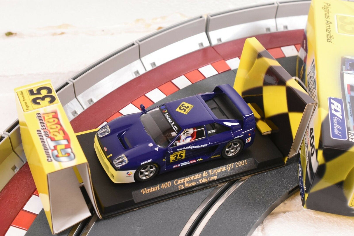 Blue race car on track with event signage for FLY CAR PA 6