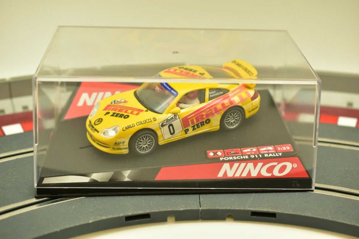 Yellow Porsche 911 race car in clear display case on a base for Ninco 50256