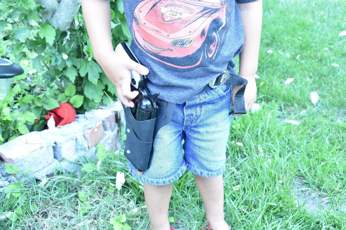 Child holding toy gun near green foliage and grass for Parris Toys 4708B