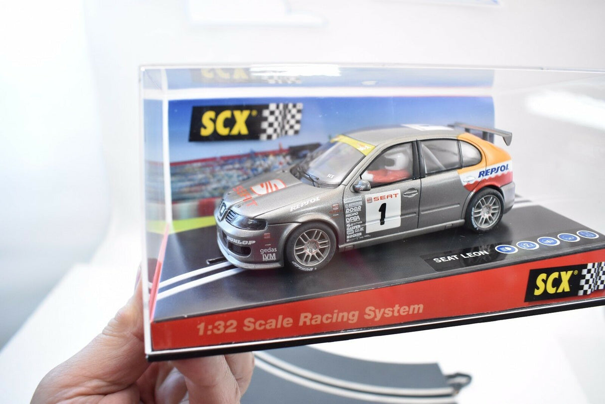 Slot car of a 2002 Cup Seat Leon race car on a display base for SCX 60930