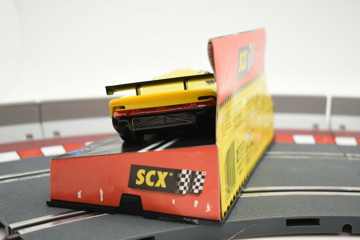 Model car packaging on a track surface for SCX Analog 60150