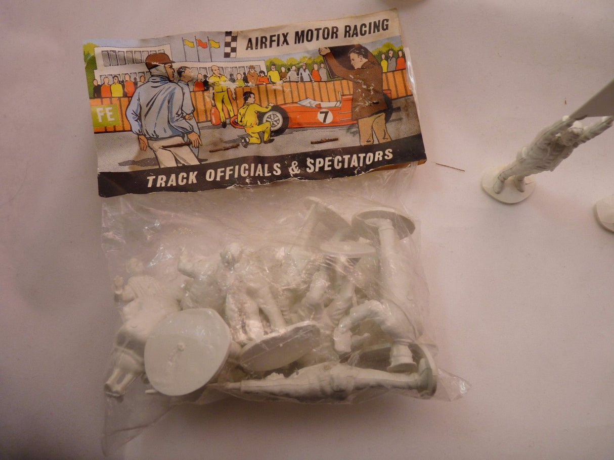 Unpainted plastic figures: motor racing track officials and spectators for AIRFIX