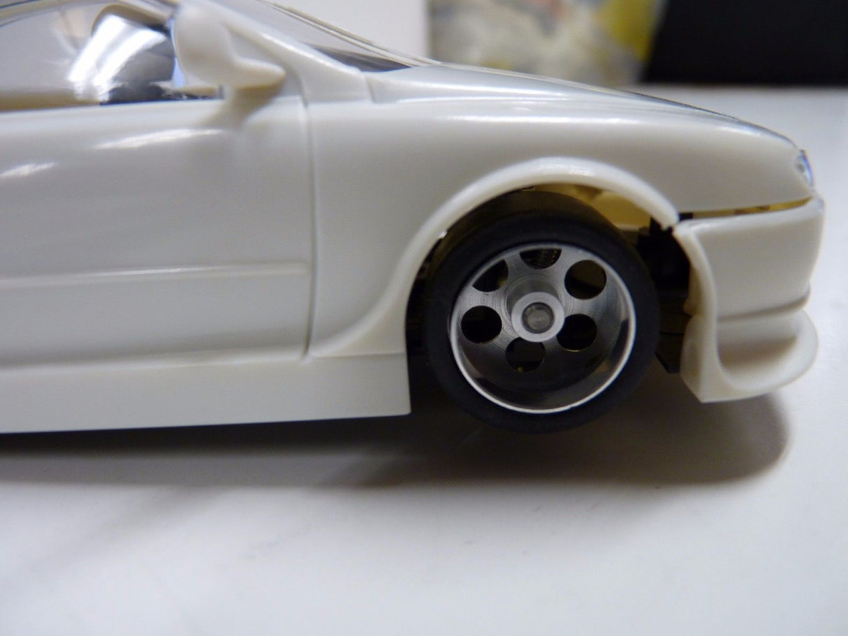 White slot car, showing a detailed wheel and front fender for Spirit 050111