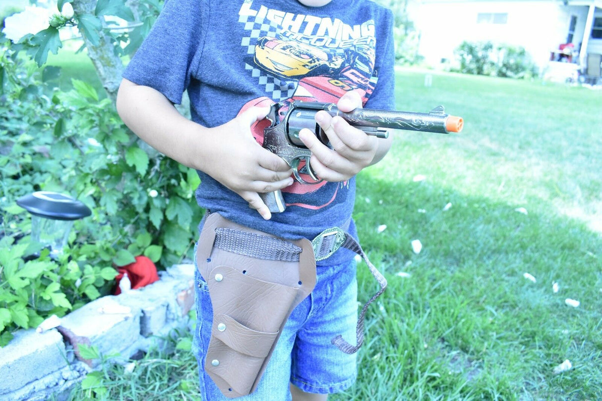 Boy holding a toy pistol and holster set outdoors for Parris Toys 4711, front view