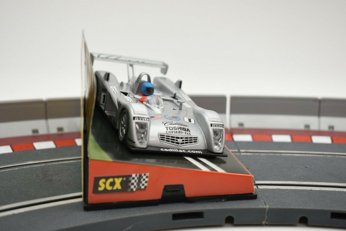 Scale model of a vintage Cadillac Northstar race car on a track for SCX 60470