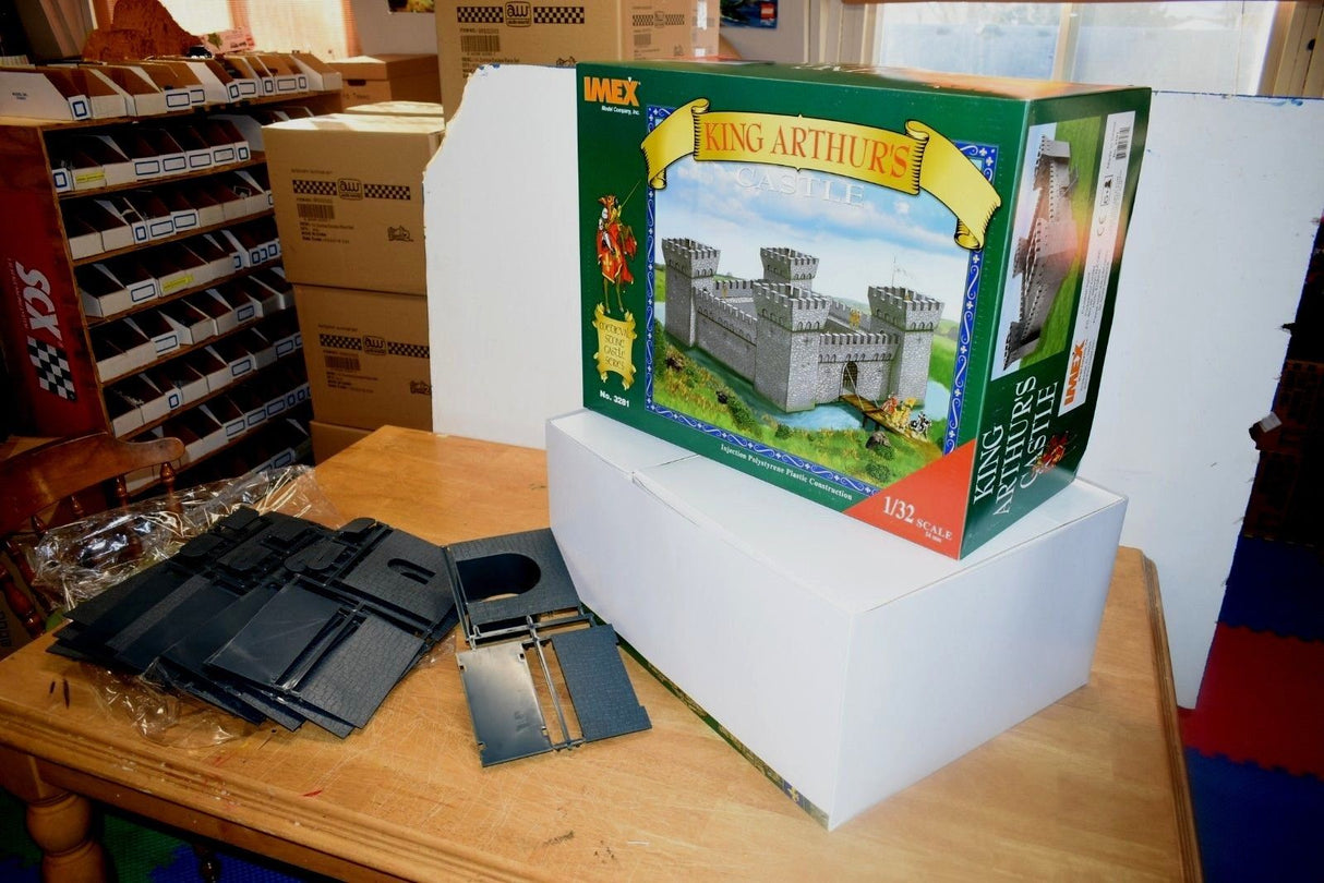 Model kit box for King Arthur's Castle and unassembled grey plastic pieces for IMEX IMX3281