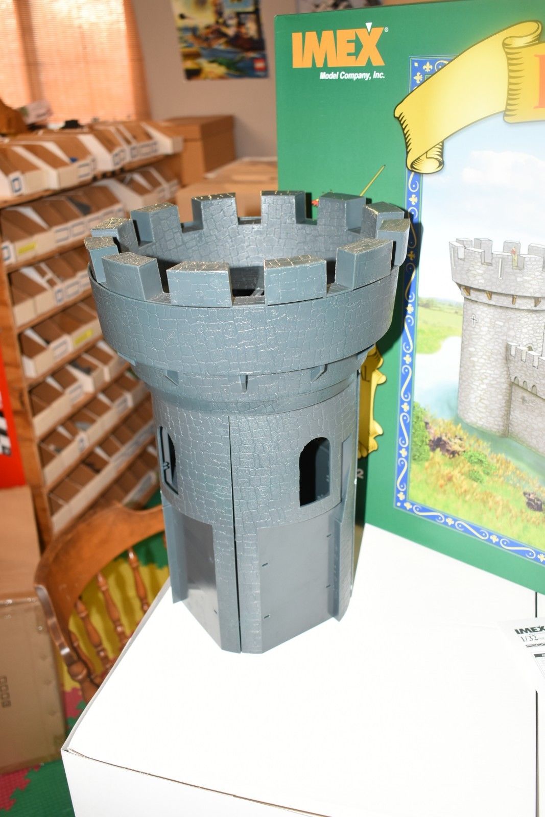 Gray castle turret model on a green box featuring a castle scene for IMEX IMX3282
