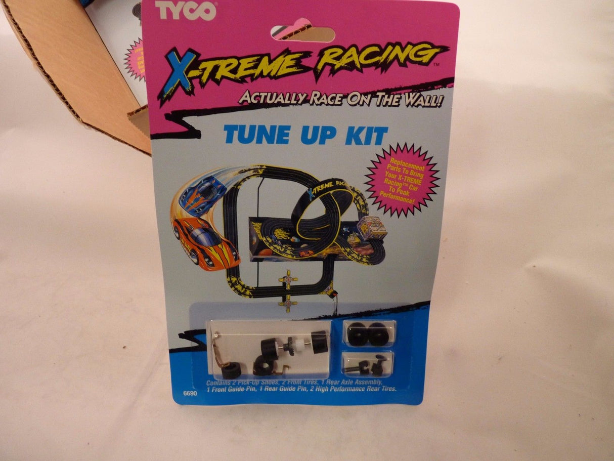 Racing car tune-up kit contents: tires, axle, and guide pins for Tyco 6690