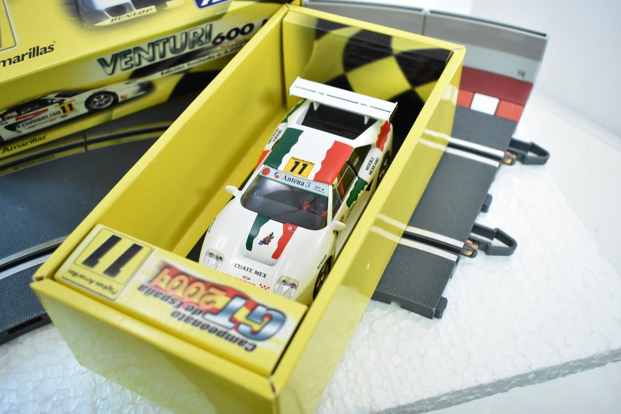 Scale model race car in a yellow display box for Fly Car PA2