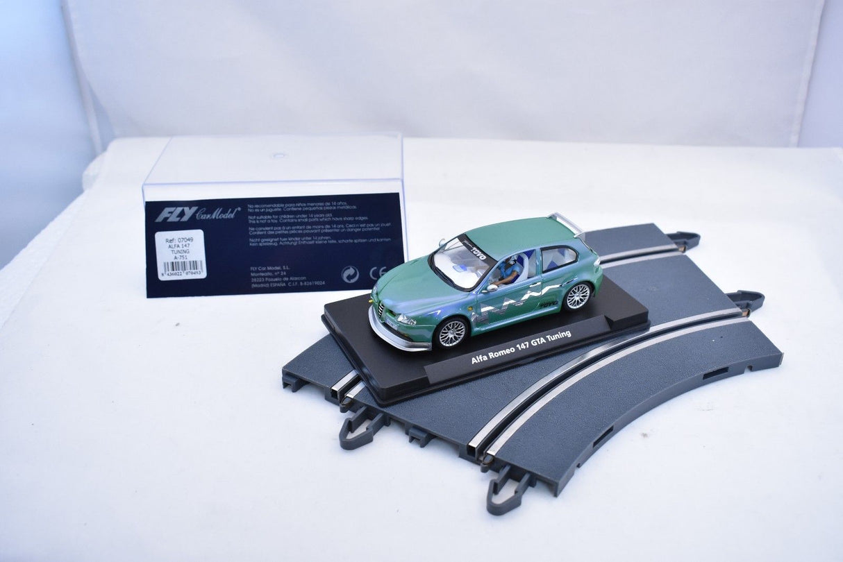 Green slot car on a display base for Fly Car 07049