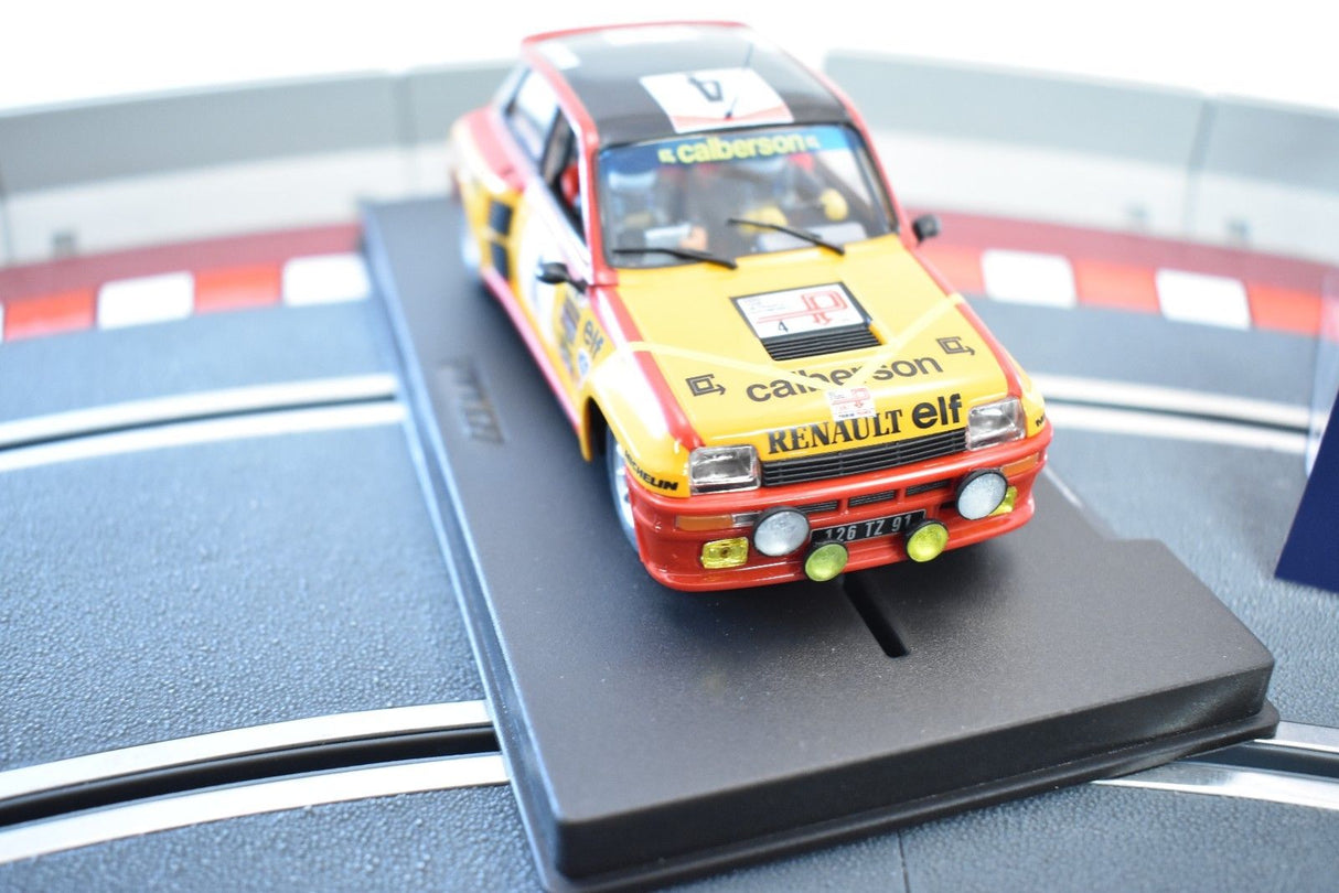 Red and yellow slot car, Renault 5 Turbo, on a display stand for Fly Car 88179