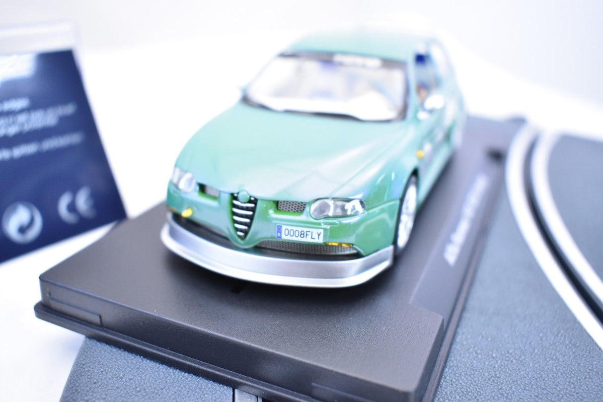 Green scale model car on a dark display stand for Fly Car 07049