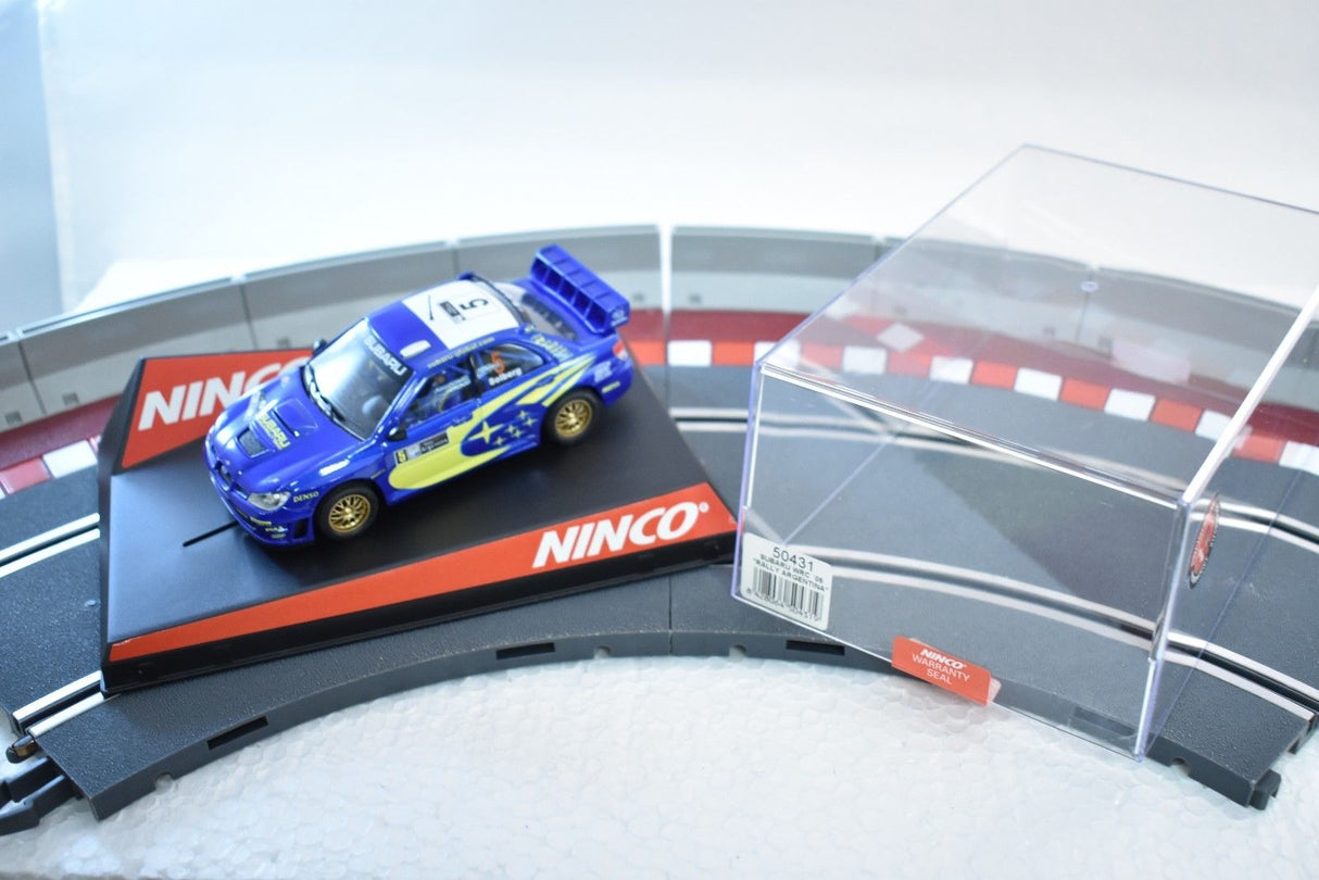 Blue Subaru WRC slot car on track with display case for ZZ Expired Kim Collection 50431