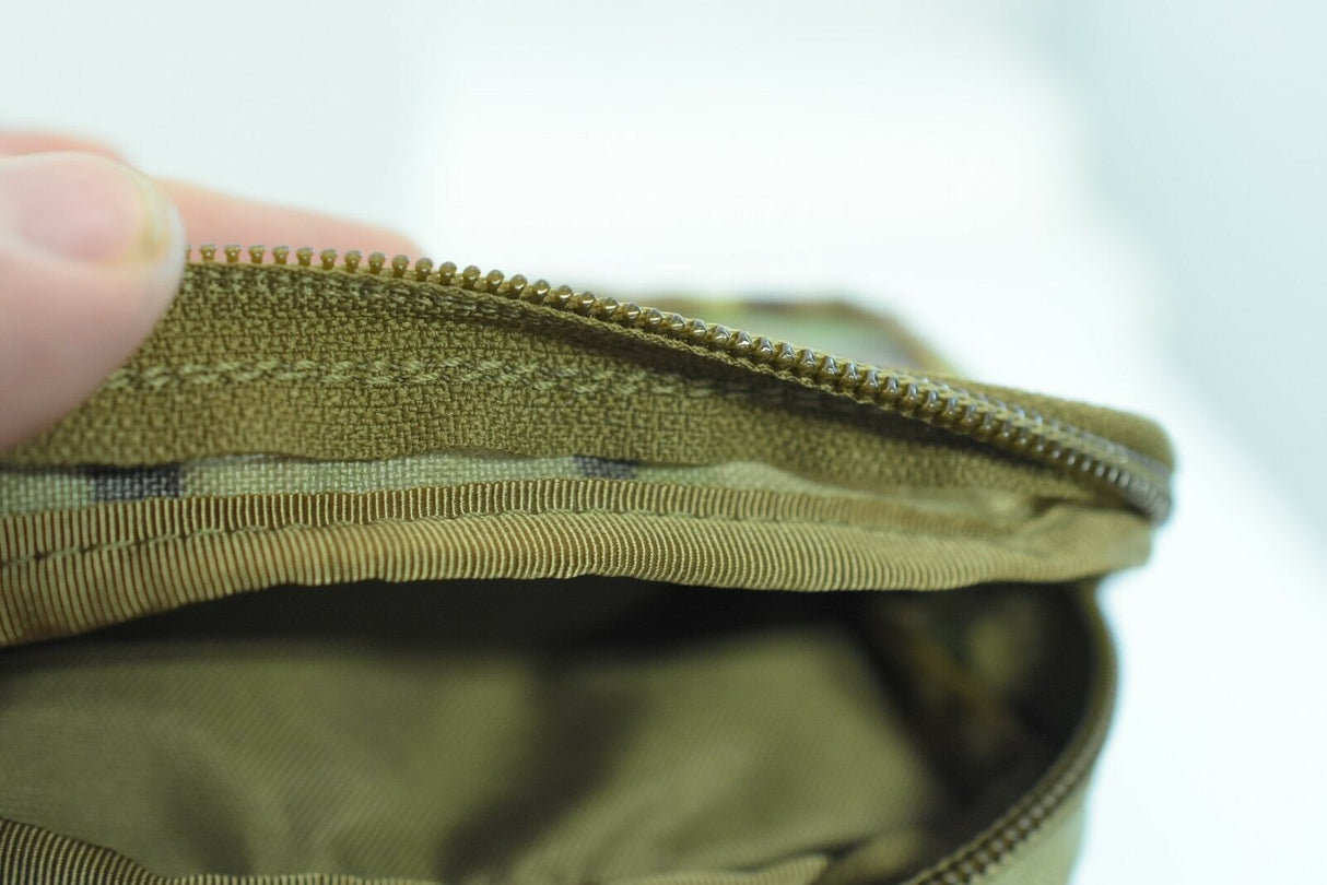 Zippered pocket opening on a khaki-colored wallet for While The Cigars Lit WTCL001