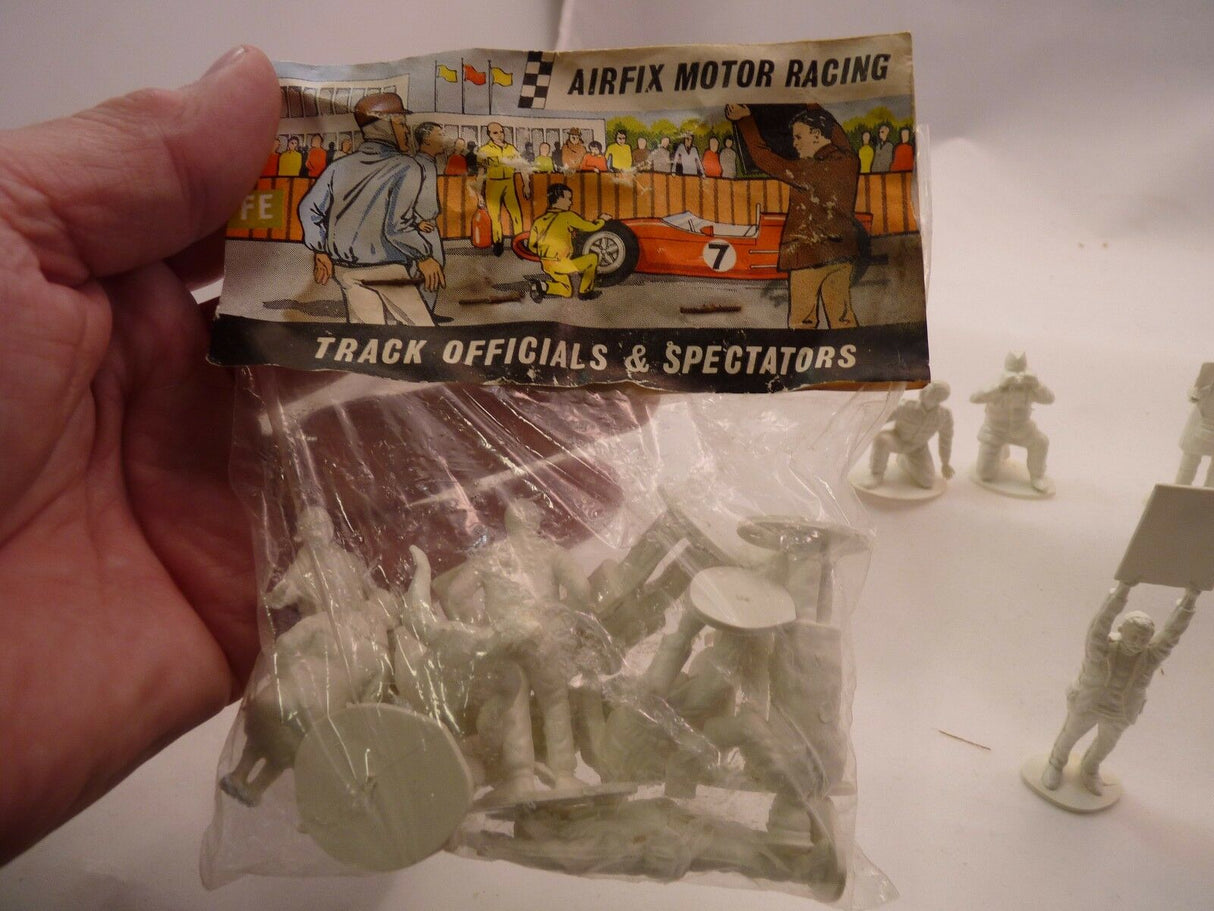 Unpainted miniature figures: motor racing track officials and spectators for AIRFIX