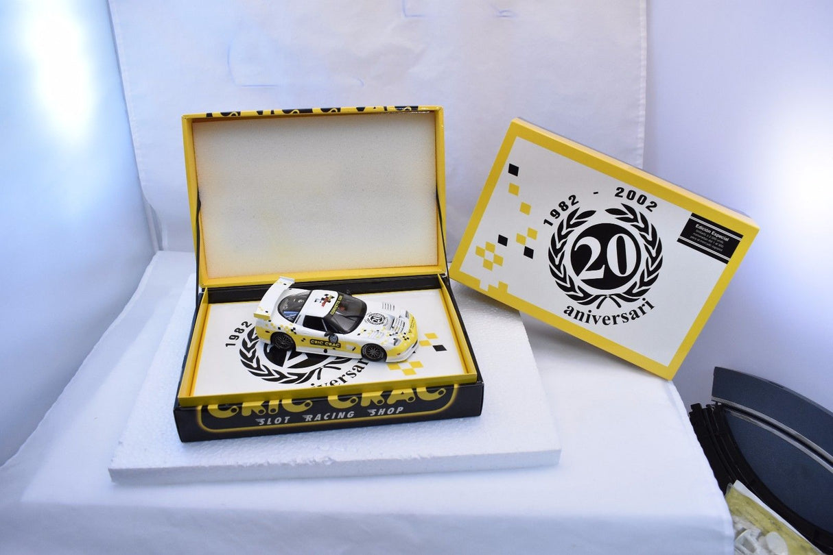 Yellow slot car in open box with anniversary commemorative card for Fly Car E123
