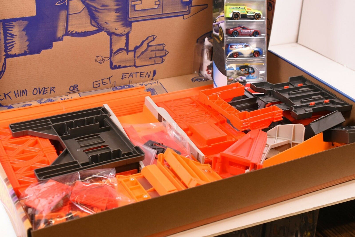 Hot Wheels track building set with orange and black plastic pieces and cars for Mattel DWW97