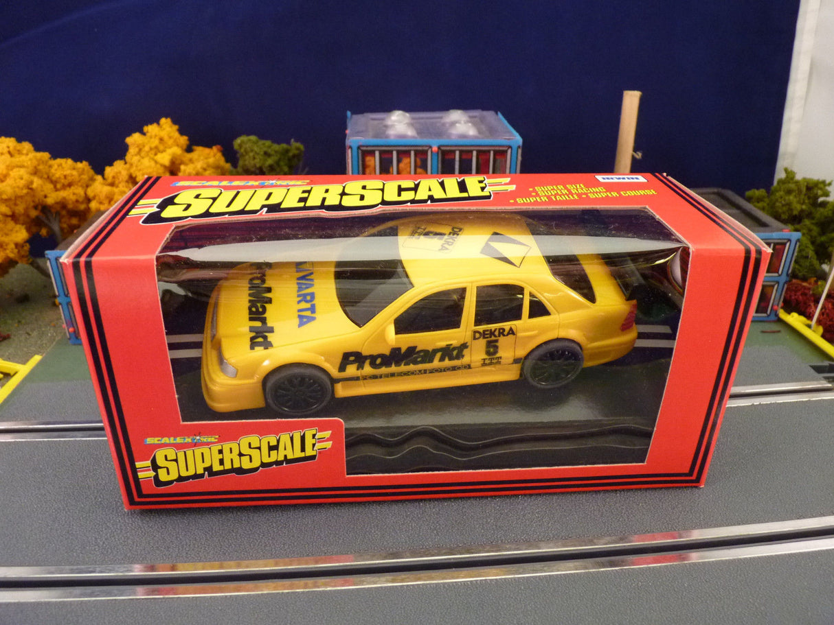 Yellow scale model car box featuring a Mercedes AMG C-Class for SCX C.699