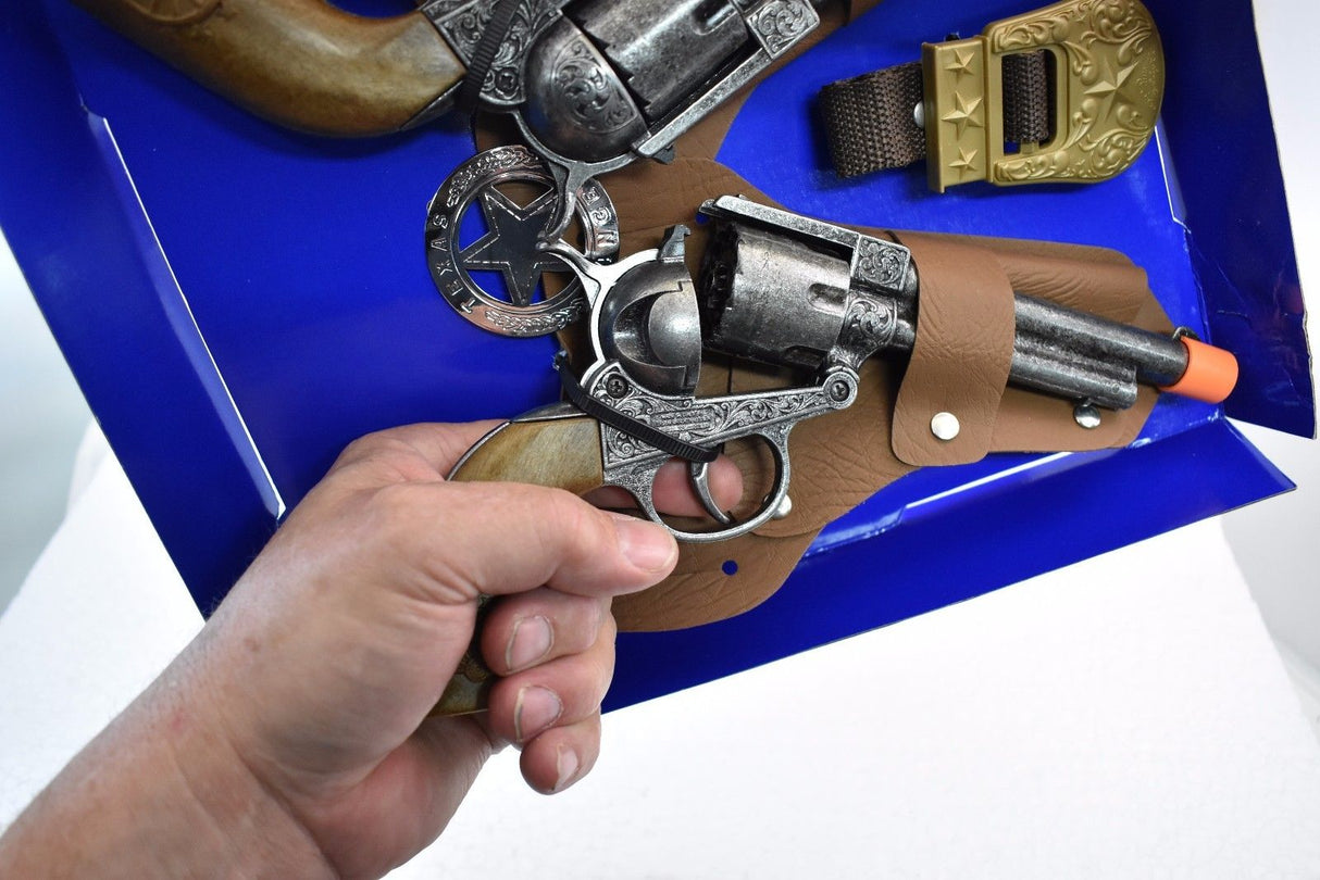Hand holding a replica revolver from a Texas Ranger double holster set for Parris Toys 4618, rear view