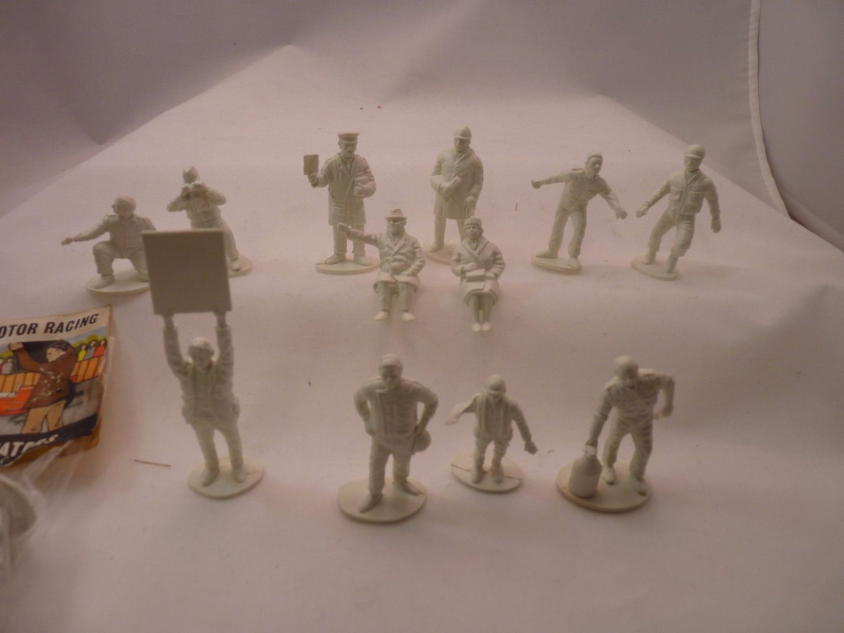 Unpainted miniature figures: racers and spectators for a motor racing scene for AIRFIX