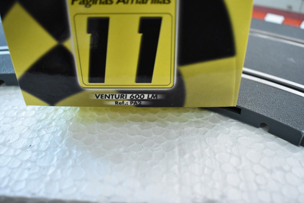 Yellow and black race number "11" on a car part for Fly Car PA2