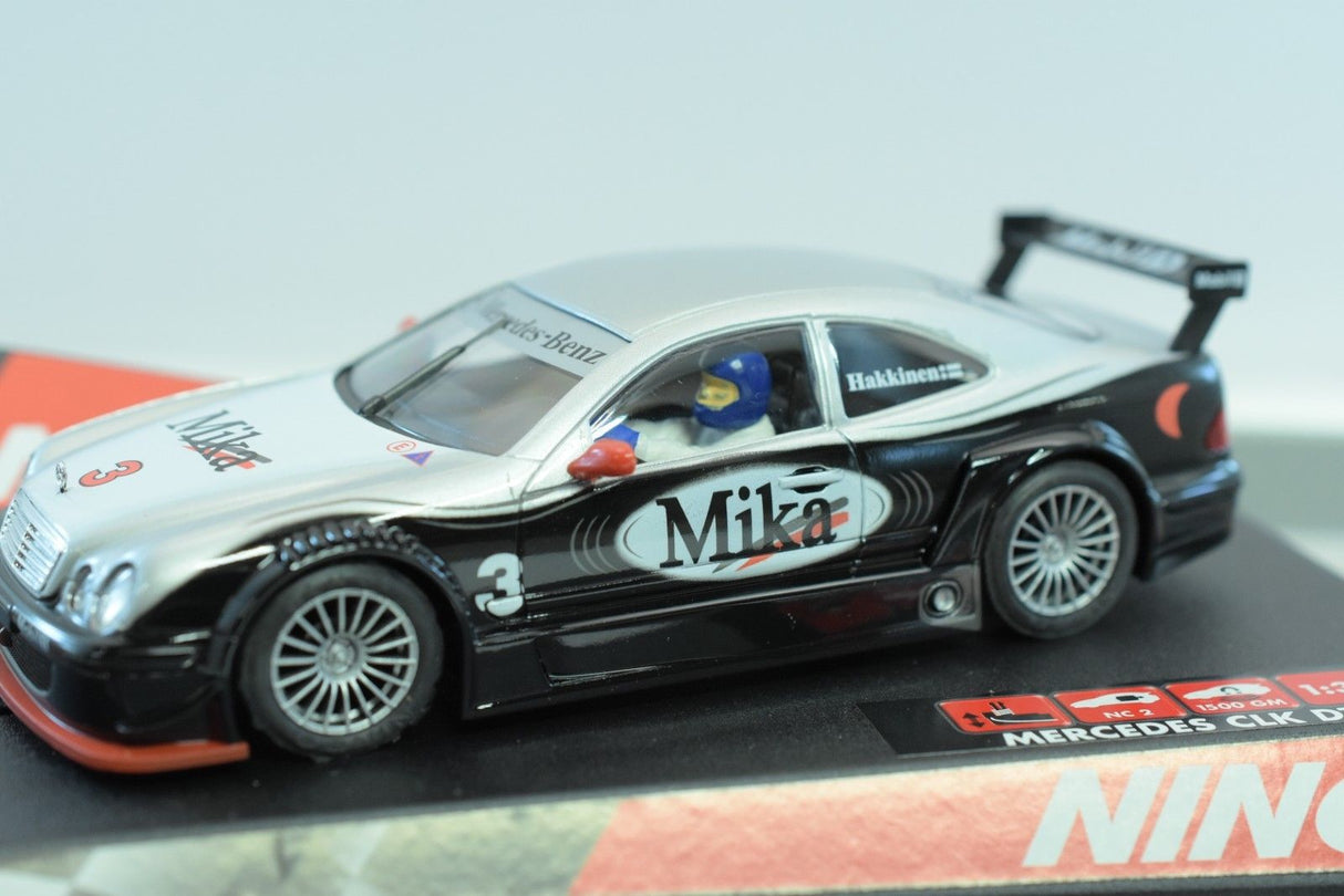 Black and silver Mercedes CLK DTM slot car with "Milka" branding for REH Ninco 50265