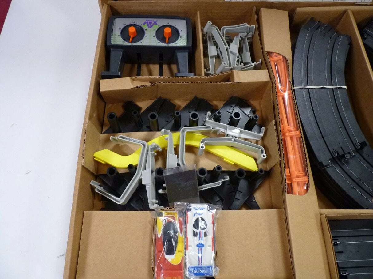 Race car track components in a cardboard box for Aurora / AFX / Tomy 9115M