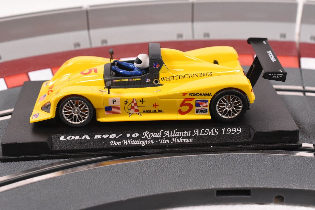 Yellow race car model on a display base, representing a 1999 race car for Fly Car 88038