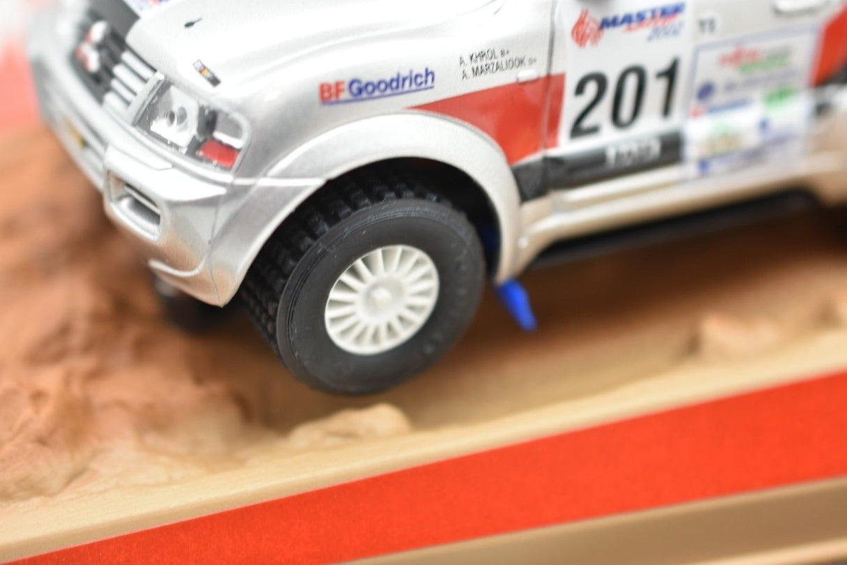 Silver scale model of a Mitsubishi Pajero SUV on a dirt surface for Ninco 50314