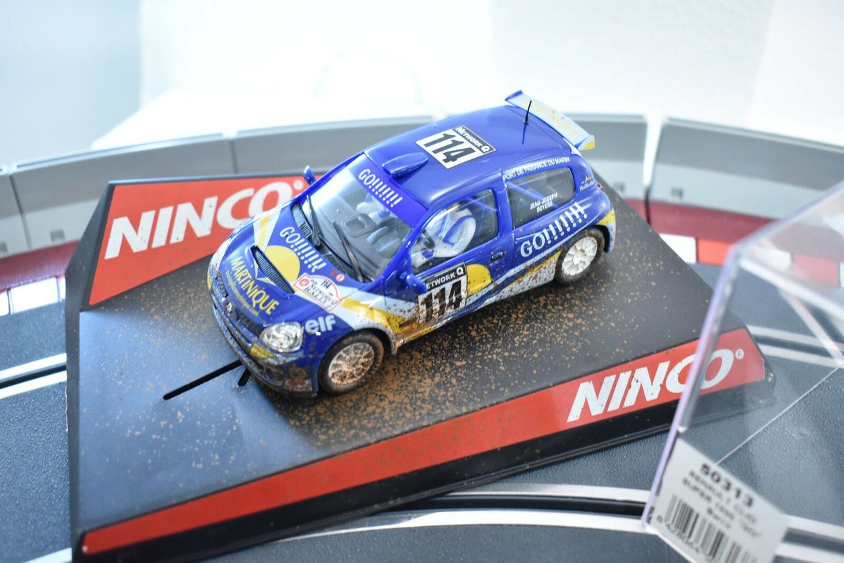 Blue race car model with "Go!!!!" text, dirt effect, on a display base for Ninco 50313