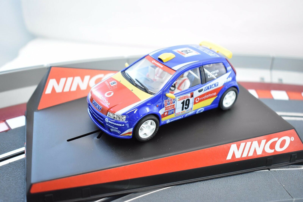 Blue and red Fiat Punto race car toy on a track base for NINCO 50336