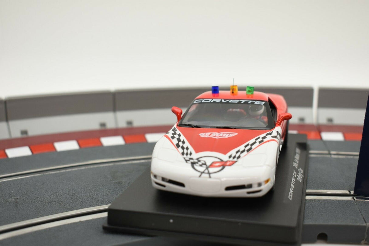 Red and white Corvette race car model on a track section for Fly Car 99006, track view