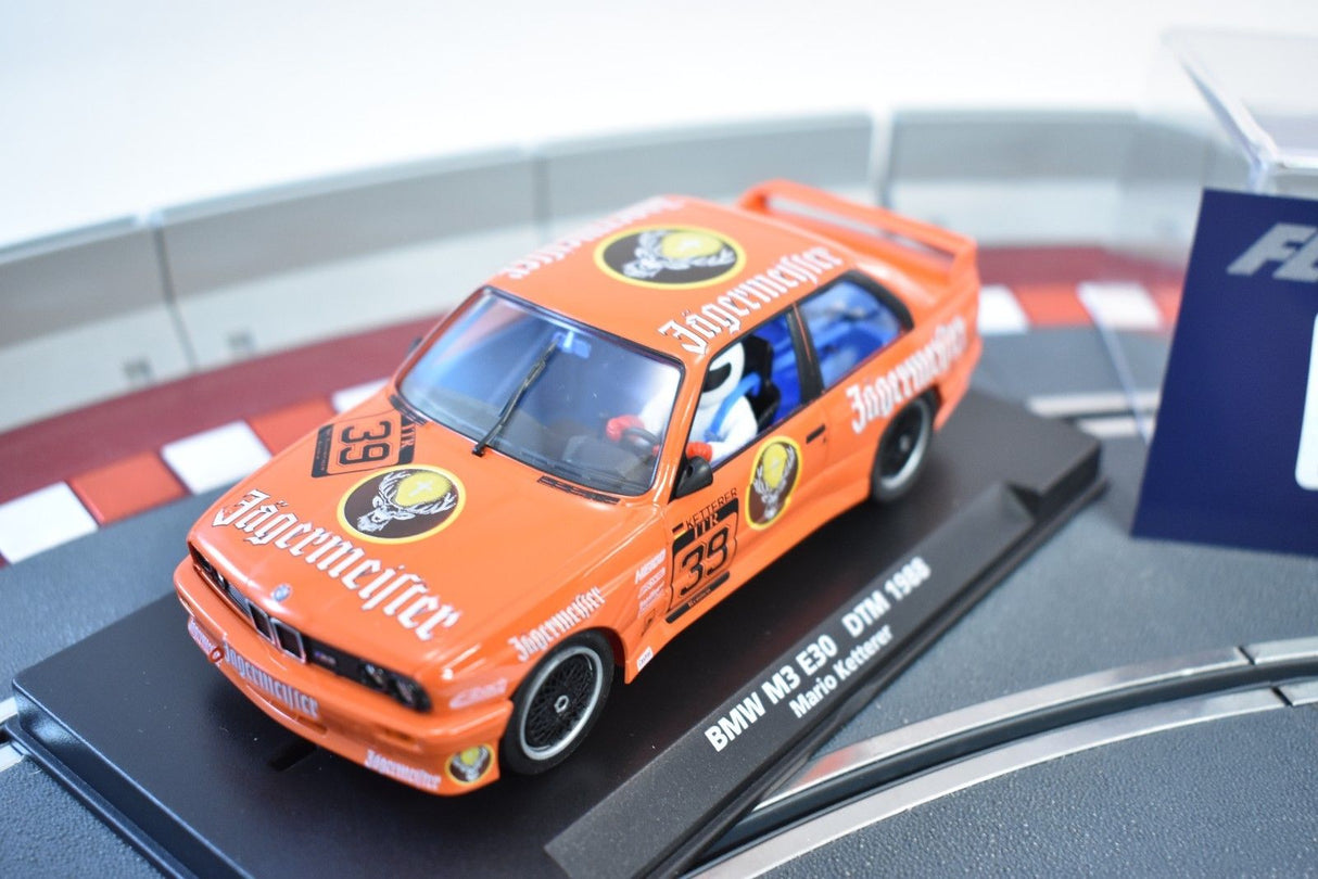 Orange slot car of a 1988 BMW M3 E30 DTM race car for Fly Car 88217