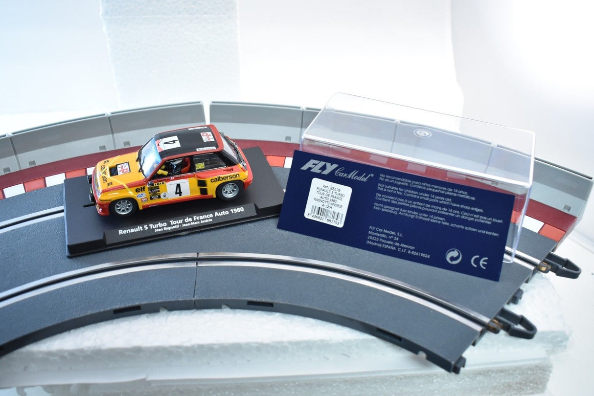Slot car of a 1980 Renault 5 Turbo race car on a display stand for Fly Car 88179