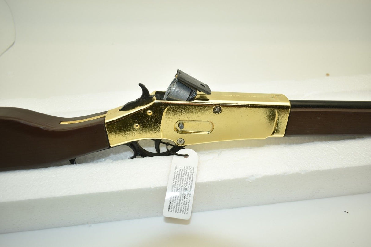 Golden rifle toy with brown stock, lying on white foam for Parris Toys 2703C