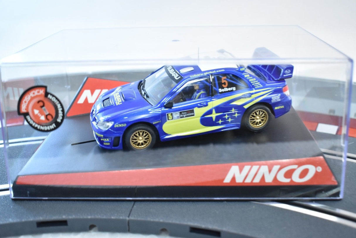 Blue Subaru WRC slot car on a display base for ZZ Expired Kim Collection 50431