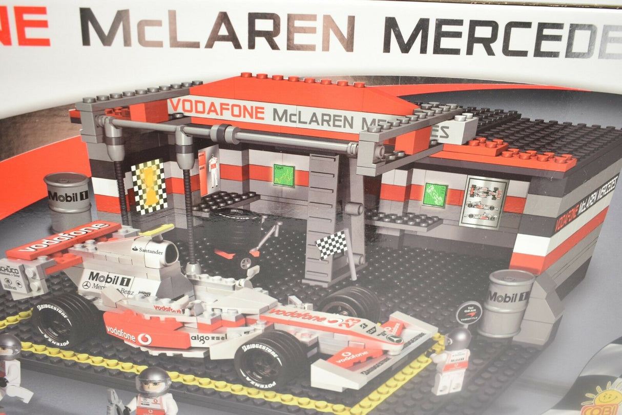 Toy model set of a Vodafone McLaren Mercedes race car and garage for COBI COBI22550