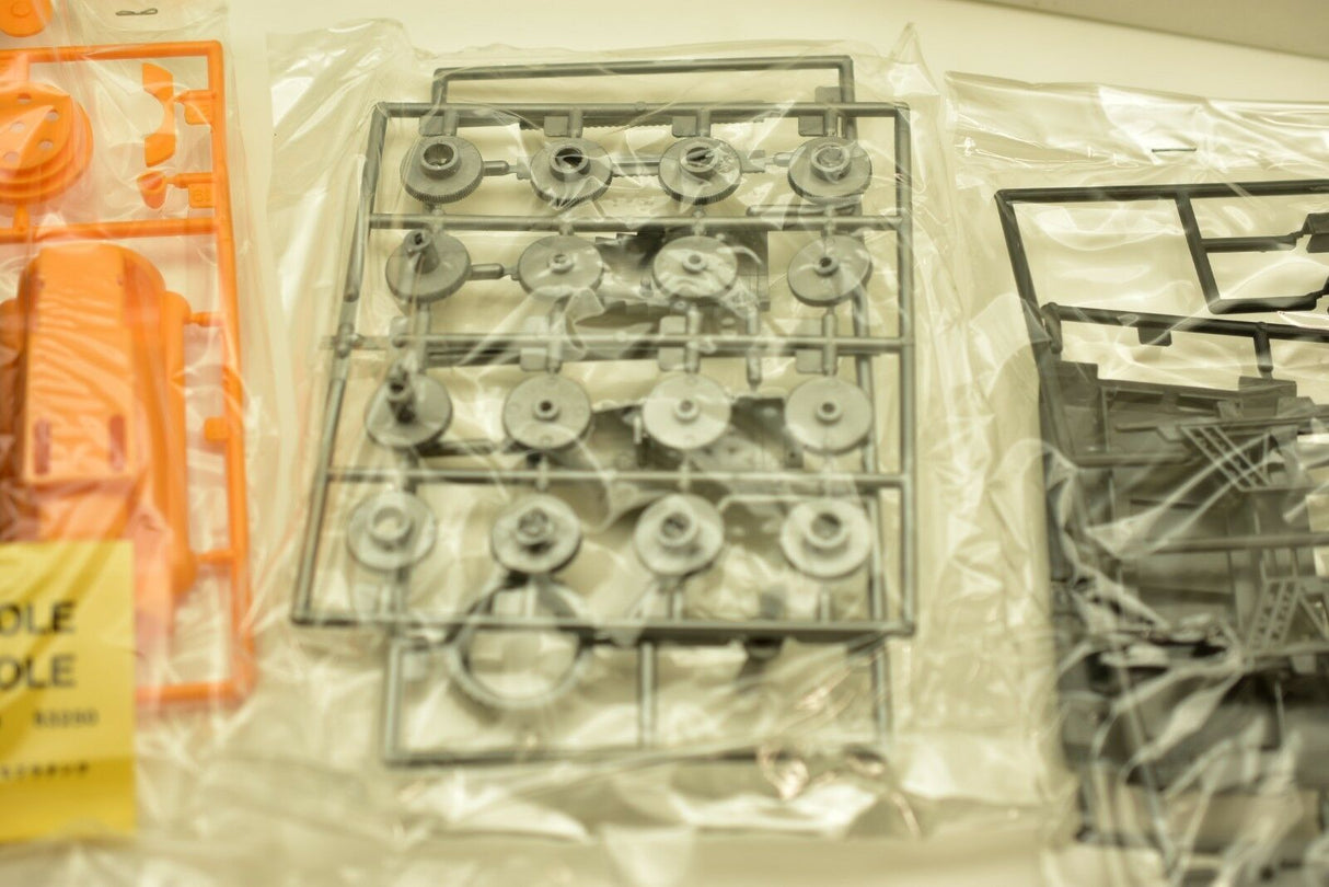 Metal parts kit laid out in plastic packaging for a model build for IMEX imx1214