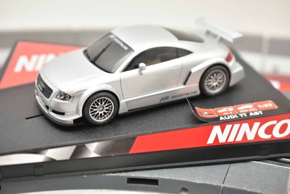 Silver slot car of an Audi TT-ABT sports car on a display base for Ninco 50252