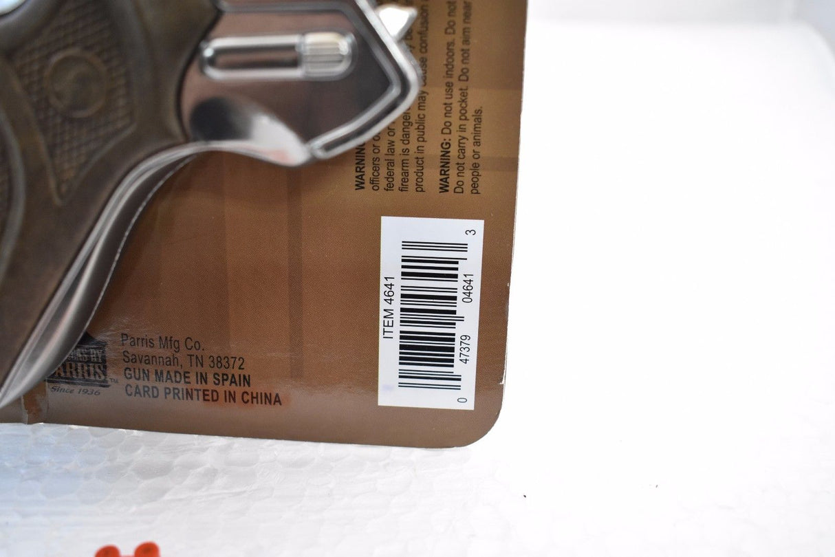 Toy gun with warning labels and product information printed on the packaging for Parris Replica 4641C