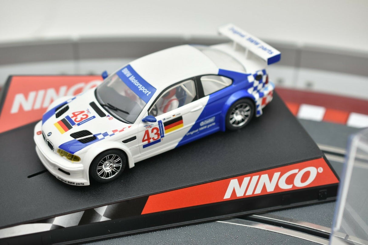 White and blue BMW M3 GTR slot car racer on a track for REH Ninco 50271