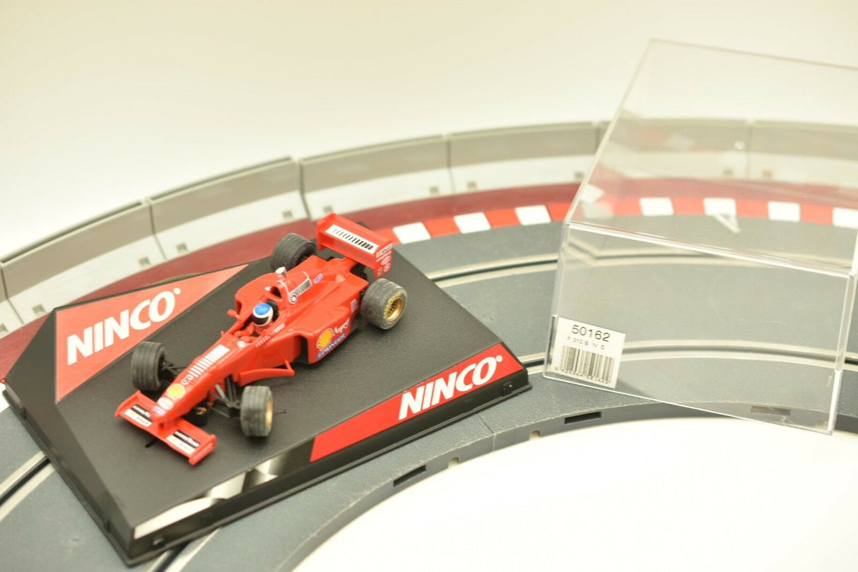 Red Ferrari slot car on a track section with NINCO branding for ZZ Expired Kim Collection 50162