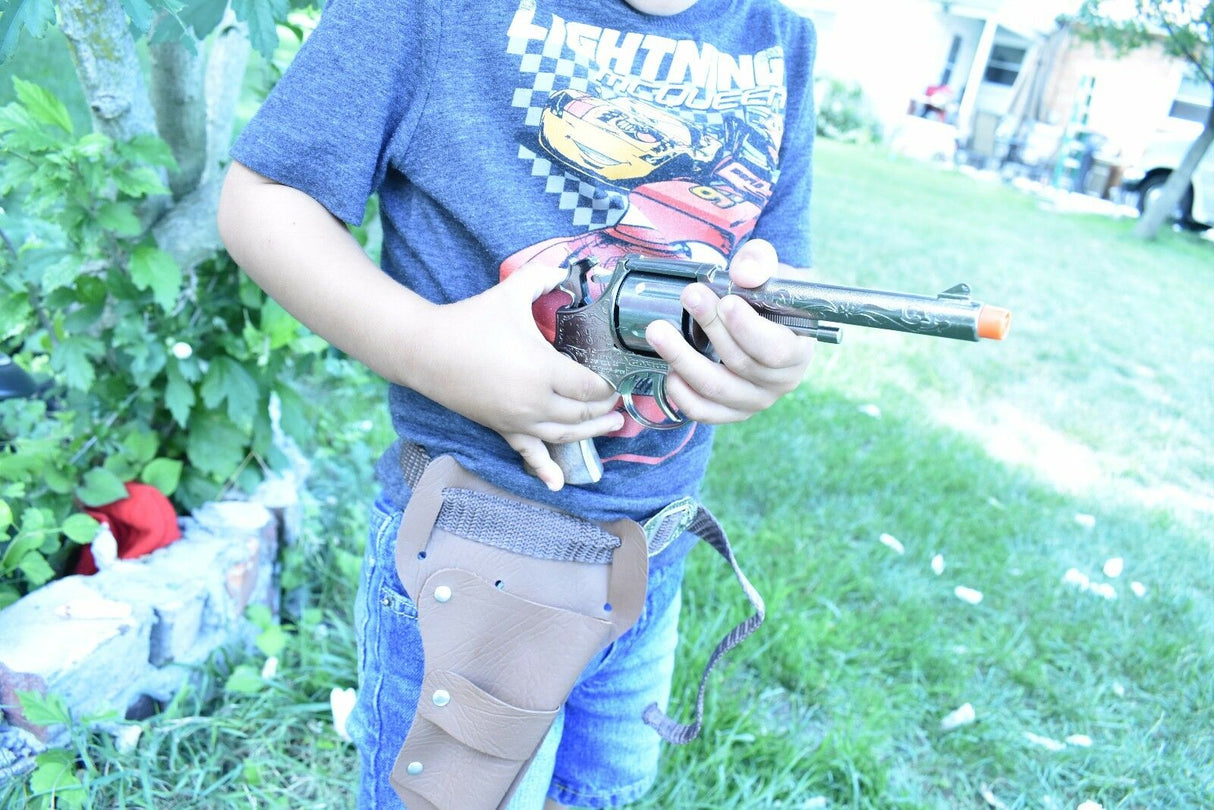 Boy holding a toy pistol and holster set outdoors for Parris Toys 4711, rear view