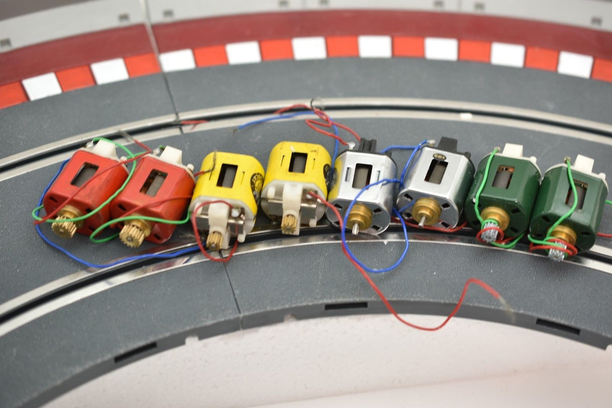 Eight small electric motors connected by wires, arranged in a row for Mabuchi 8-Motors