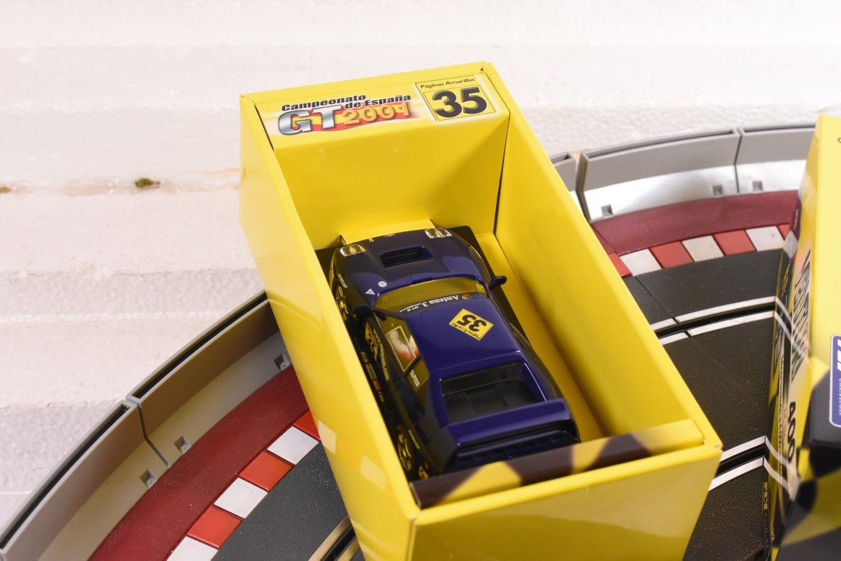 Yellow display box holding a dark blue race car model for FLY CAR PA 6