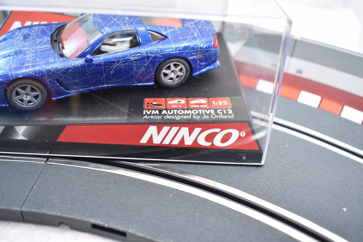Blue model car on a track base with "IVM AUTOMOTIVE C12" text for Ninco 50248