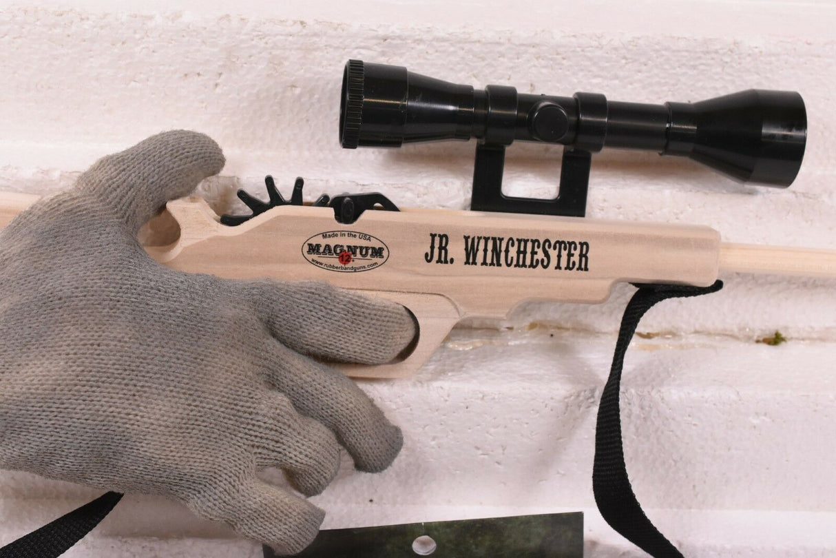 Hand holding a wooden rifle with scope and ammo for Magnum Rubber Band Guns GL2JRWNCHSTRSS